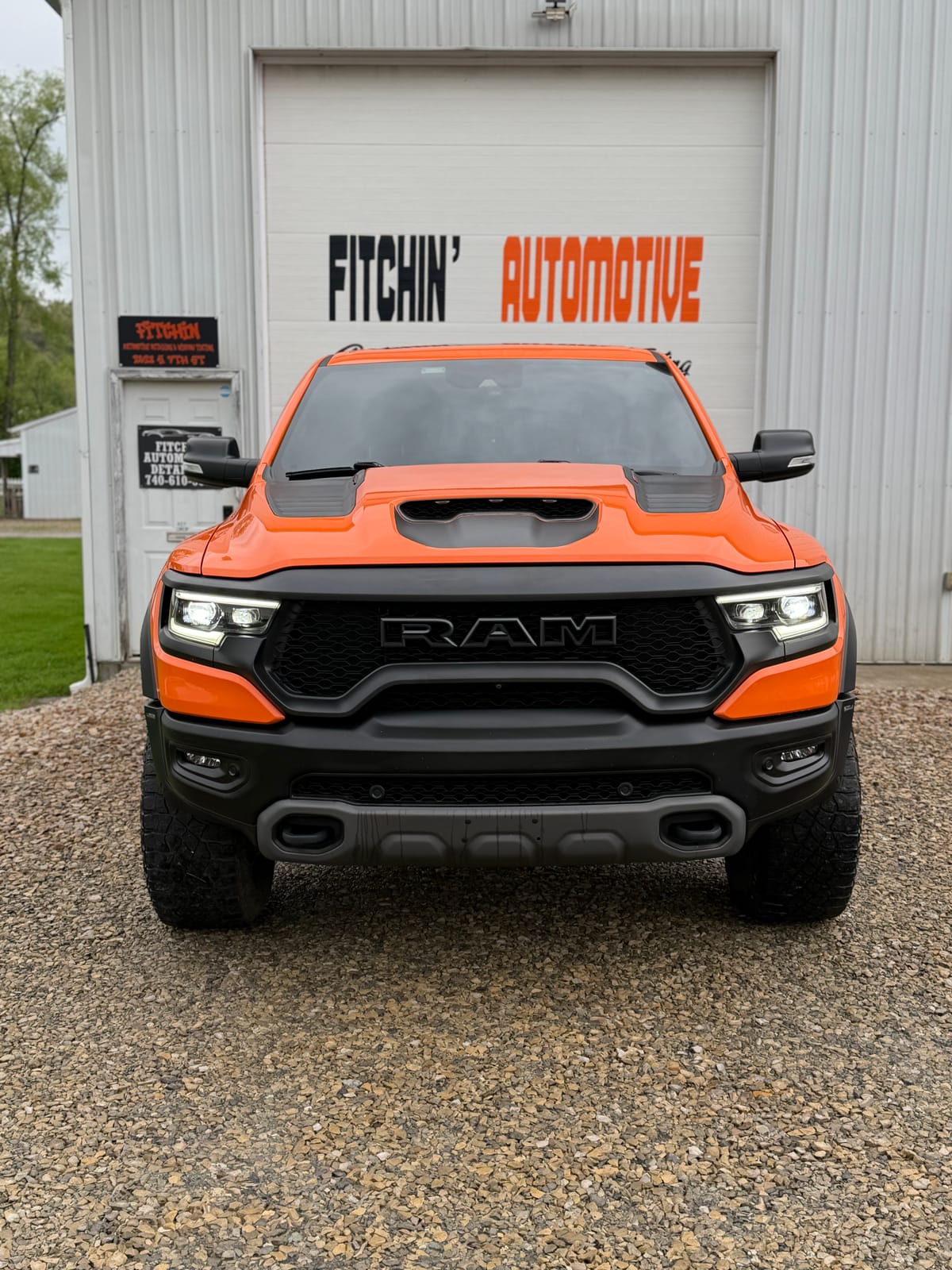Front view of a customer's orange Ram TRX outside the Fitchin' Automotive shop in Coshocton, Ohio