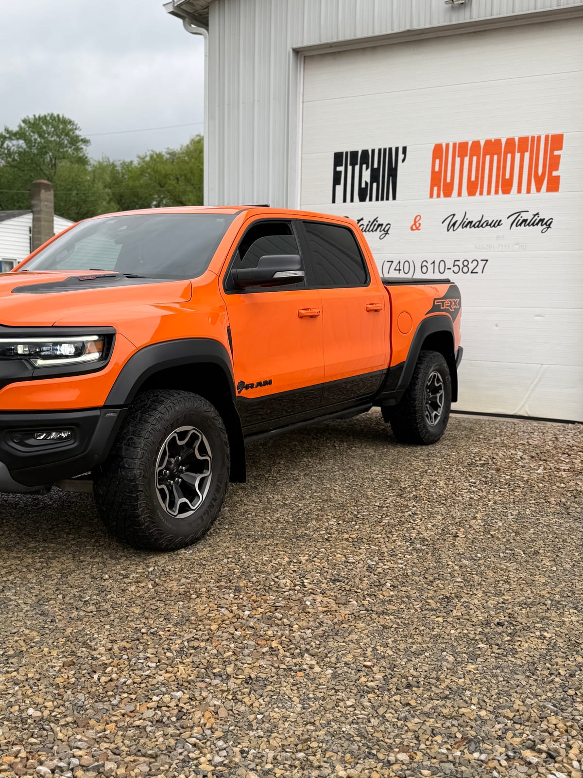 Customer's orange Ram TRX parked in front of the Fitchin' Automotive shop in Coshocton, Ohio — Detailing & Window Tinting (740) 610-5827